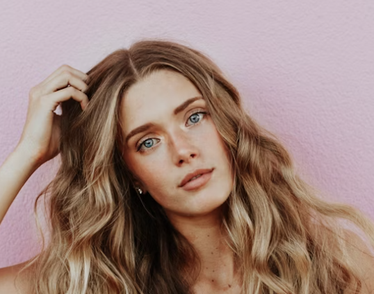 Blonde woman pink background portrait